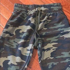 Army sweatpants with red stripe on side.